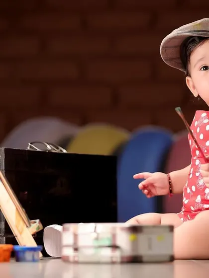 A creative "little artist" themed baby photoshoot. We have a variety of props and concepts available at our studio to make your child's session unique.