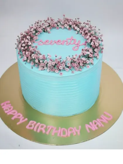A simple and beautiful cake for a 70th birthday. This fresh pineapple buttercream cake is decorated with a wreath of delicate baby's breath flowers.