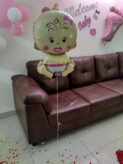A cute baby-shaped foil balloon used in our 'Welcome Baby' decoration packages.