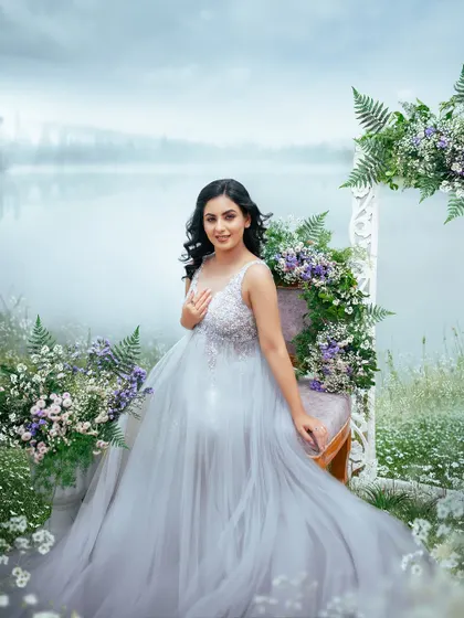 A beautiful, smiling portrait of the mom to be. The soft lighting and surrounding flowers create a gentle and joyful mood for this outdoor maternity session.