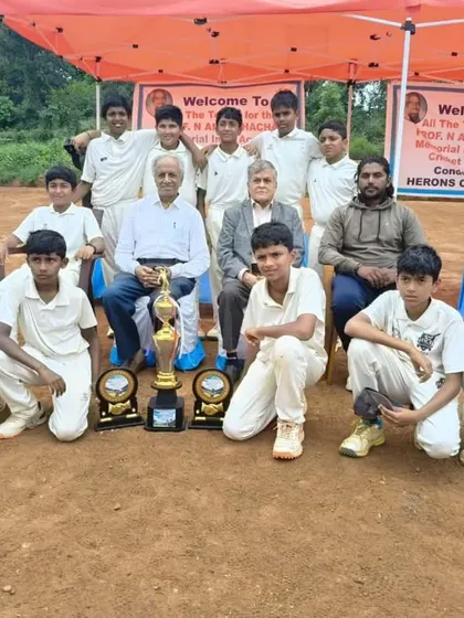 The team posing with officials and trophies after a tournament victory.