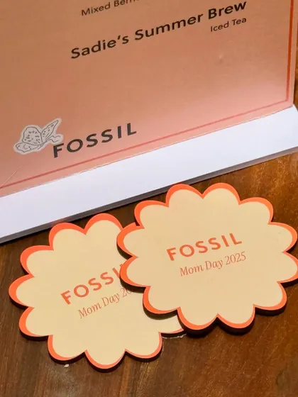 It's all in the details. For the Fossil Mother's Day event, we created custom-branded floral coasters and menus that tied the entire theme together, ensuring a cohesive and memorable brand experience for every guest.