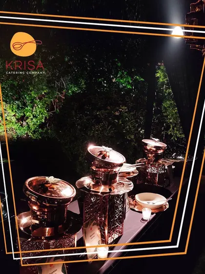 An evening shot of our elegant copper serveware under soft lighting. This image highlights how our presentation creates a luxurious and sophisticated ambiance, even in an outdoor, natural setting.
