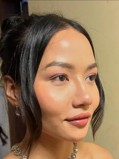 I genuinely can't get over this glowing skin. This close-up shows a soft, romantic makeup look with a focus on a dewy, flawless complexion.