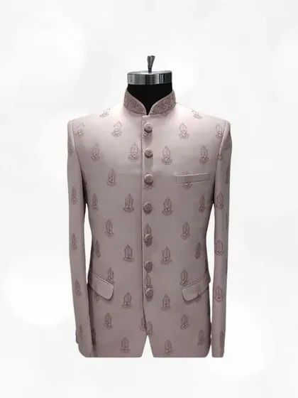Simple yet elegant, this light pink Jodhpuri suit with subtle buti embroidery is a testament to timeless style. A great addition to any formal ethnic wardrobe.