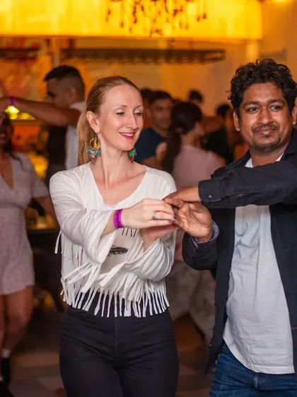 A stylish dancer with a fringed top, moving with grace and confidence.