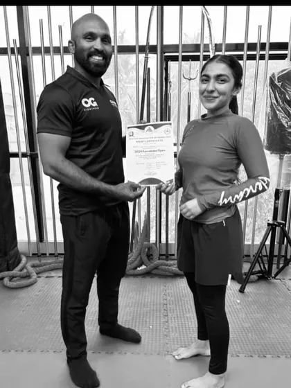 Presenting a certificate of achievement to Yusra Akef Siddiqi, one of our top female fighters and a national grappling champion.