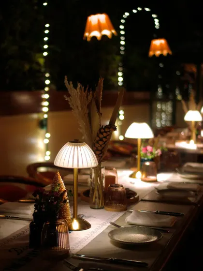 The beautifully arranged tablescape for our Rajputana Christmas dinner. The decor, with its warm lighting and elegant details, was designed to evoke the spirit of the desert.