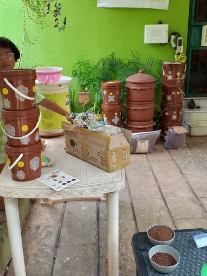 Preparing the setup for a workshop. We ensure all materials, from different composter models to samples of finished compost, are ready for a complete hands-on learning experience.
