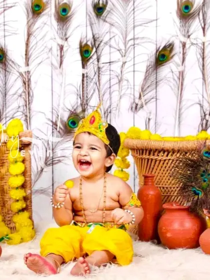 The playful spirit of childhood shines in our Little Krishna themed photoshoot. We create a vibrant and authentic setting with peacock feathers, marigold garlands, and traditional clay pots, capturing your child's joyful laughter and divine charm.