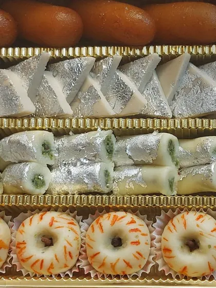 This assorted mithai box is a celebration in itself. It features a beautiful arrangement of our handmade sweets, including Kaju Katli, Pista Rolls, and fruit-inspired sandesh. We prepare these boxes for festivals and special orders, ensuring every piece is fresh and made with pure ingredients.