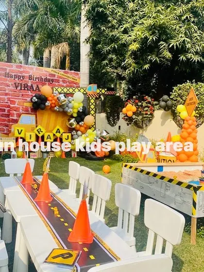 A full view of a construction-themed party, where we provided the themed sandpit and the white tables and chairs for the little guests.