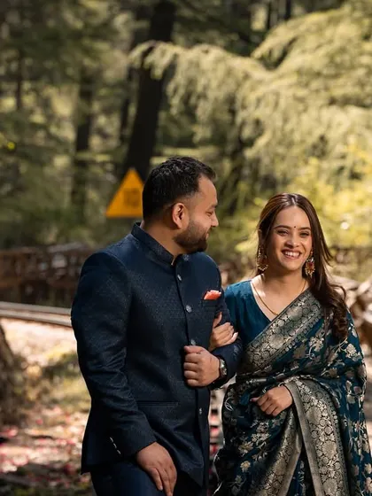 A happy stroll along a path next to the train tracks, arm in arm. This candid shot captures a simple, joyful moment of togetherness.