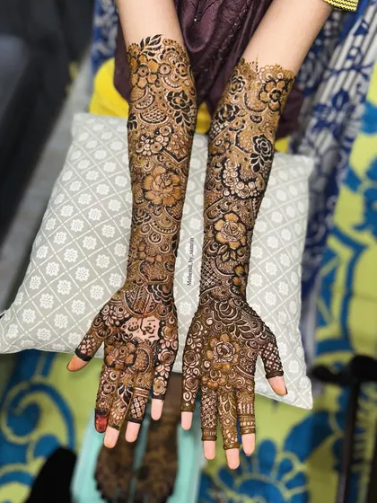 The full view of this bridal floral design. The patterns are a beautiful mix of bold flowers and delicate leaves, covering the arms completely.