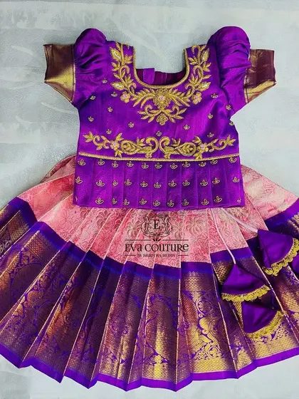 Perfect for twins or siblings, this set includes a newborn pattu lehenga and a matching kurta-dhoti. The rich purple fabric is adorned with gold embroidery, ensuring both your little boy and girl look coordinated.