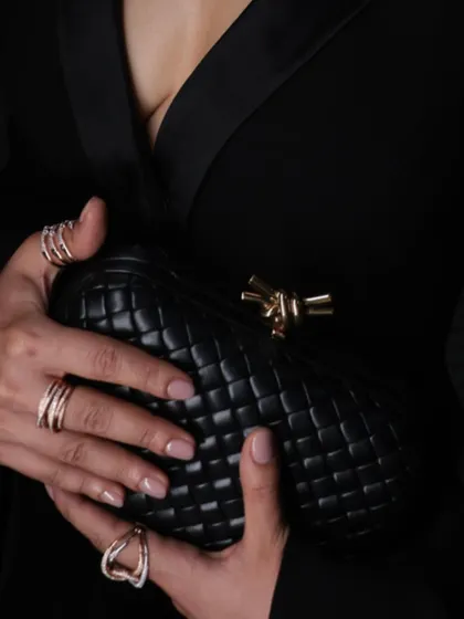 A close-up of Sanya Malhotra's hands, showcasing a curated stack of our modern gold and diamond rings.