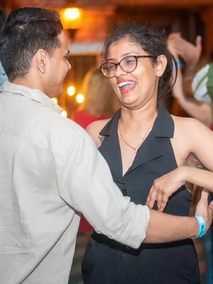 A happy and energetic dance. The joy on their faces is what La Rumba is all about.