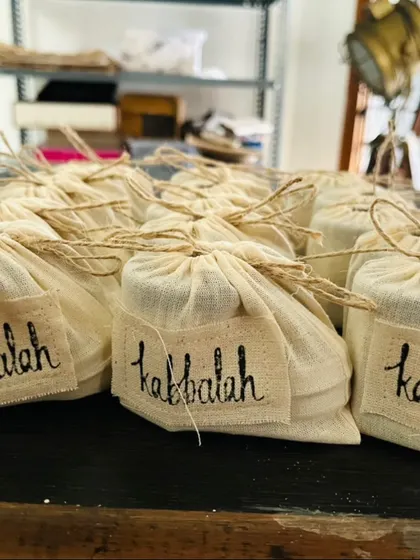 A close-up of the hand-stamped 'Kabbalah' bags I use for gifting and events. This personal touch makes each gift feel special and unique.