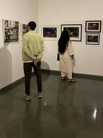 Visitors looking at a collection of black and white film stills.
