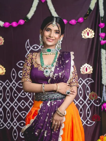 This model is wearing a beautiful emerald and polki set, perfect for a festive occasion. The combination of the choker and long necklace creates a stunning layered look.