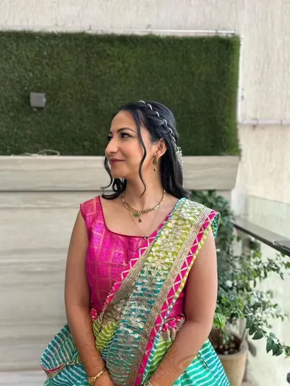 A side profile showing the soft curls and braided details of the hairstyle.