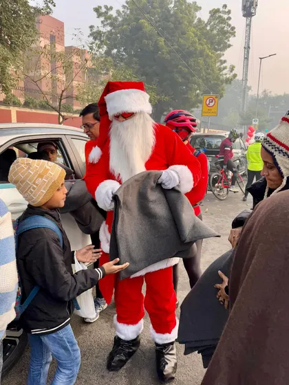 Another heartwarming moment of giving, as one of our Santas hands a blanket to a young boy.