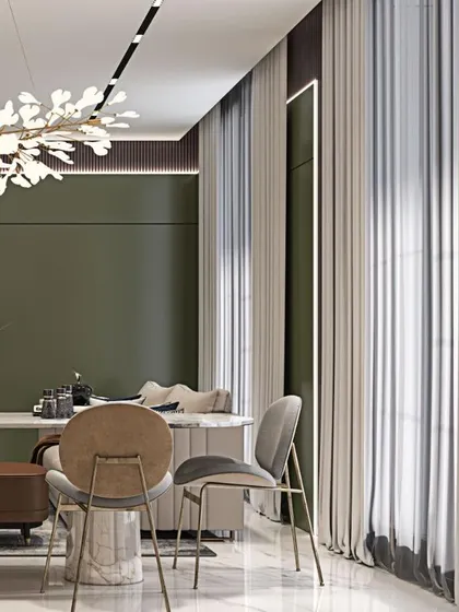 A view of the dining area, highlighting the unique chairs and the striking chandelier. The use of green accent walls and sheer curtains creates a bright and elegant space.