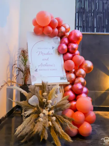 Welcoming guests in style. For the mother-daughter birthday soiree, we created this elegant entrance with a custom welcome board on an easel, framed by a cascade of metallic balloons and pampas grass.