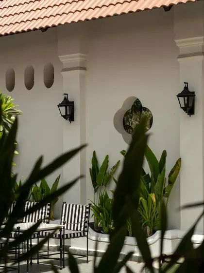 Views of the courtyard at Elgin Cafe, a space designed for pause and reflection. I used white lime-washed walls, lush tropical plants, and classic lantern-style lighting to create an intimate, serene outdoor dining experience.
