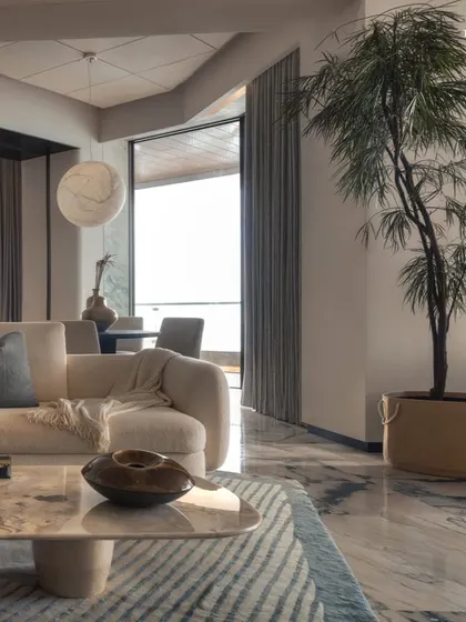 This living space at Palais Royale is designed as a tranquil sanctuary that balances calm minimalism with refined elegance. Bathed in soft, atmospheric lighting, the space evokes an intimate, almost meditative quality, perfect for quiet evenings.