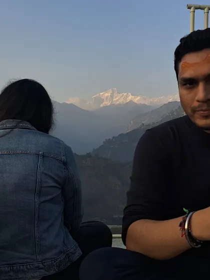 A moment of quiet reflection with the majestic Himalayas in the background.