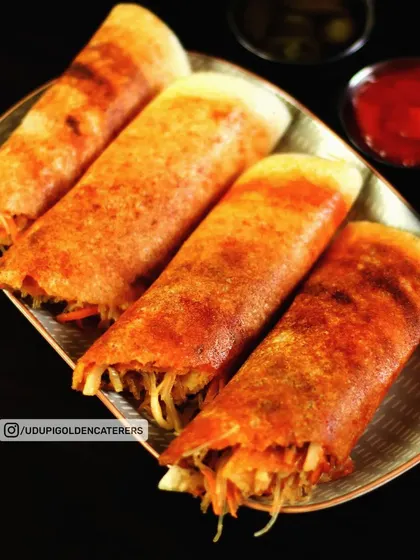 These are our popular Spring Dosas, filled with a mix of fresh vegetables and noodles for a delicious Indo-Chinese twist on the classic South Indian crepe.