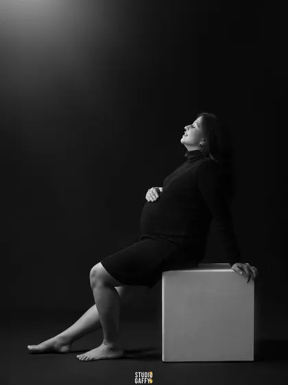 A simple, elegant, and classic maternity portrait. Using dramatic lighting in the studio, I focused on creating a serene and contemplative mood, highlighting the beautiful silhouette of the mother-to-be against a dark backdrop.