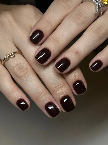 A deep, rich burgundy manicure perfect for the autumn season. The glossy finish on these short, square nails is impeccable.