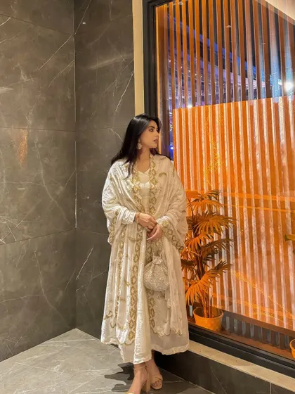 Another angle of the white ethnic outfit, highlighting the delicate details on the dupatta.