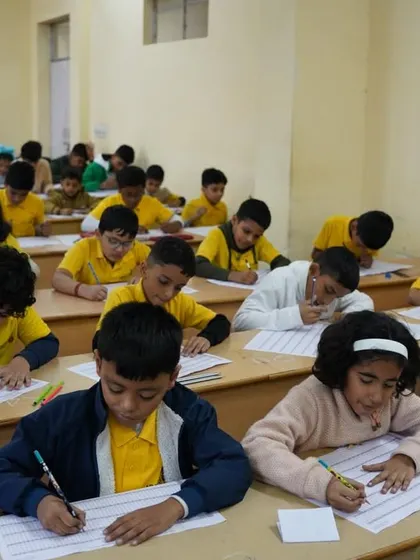 Students in yellow t-shirts, our academy uniform, focused on their practice sheets.