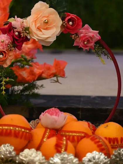 Another view of the decorated orange basket, showcasing the delicate floral hoop handle.