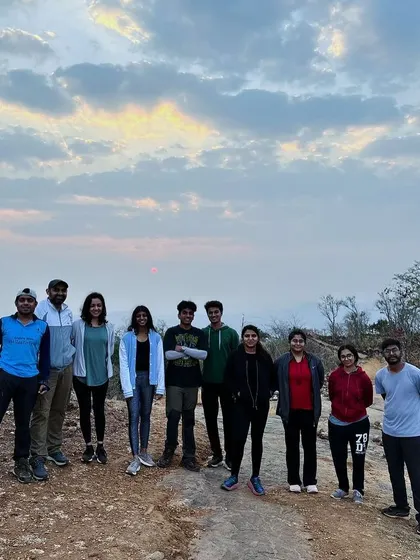 A team enjoying the early morning light during the Kabaldurga sunrise trek. The soft light and cool air make for a magical hiking experience.