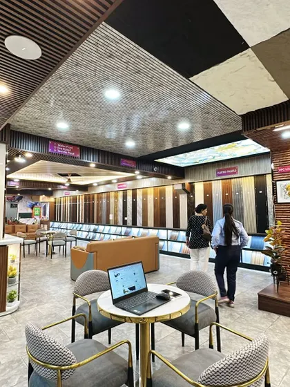 A laptop is open on our consultation table, ready to create a digital mockup for a client. We use technology to help you visualize your dream space.