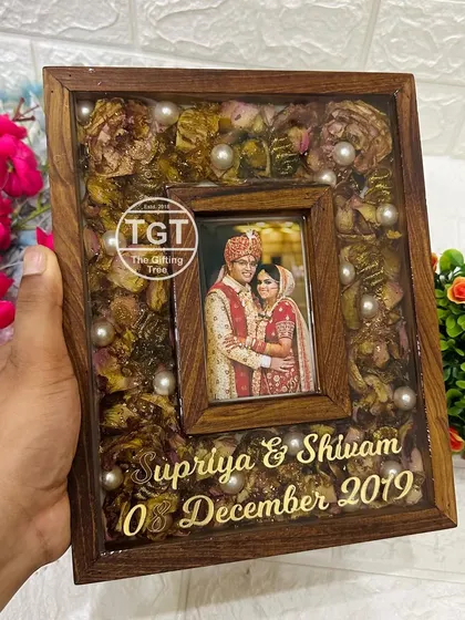 Here is a similar 8x10 inch teakwood frame, but this one is filled with preserved varmala petals, giving it a more floral and textured look.