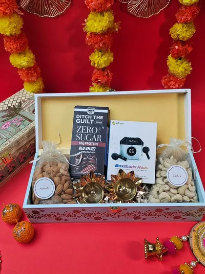 A beautiful and simple Diwali gift box. It includes premium dry fruits, a healthy sugar-free snack, and elegant diyas, perfect for a thoughtful festive gesture.