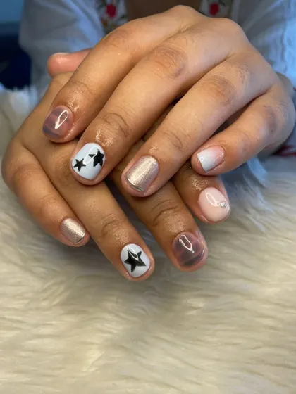 A fun gel polish set with a mix of different designs, including star art, shimmer, and ombré.