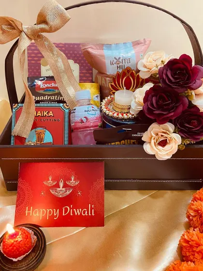 A full view of our premium leatherette basket hamper, brimming with snacks, flowers, and a diya for a complete Diwali celebration package.