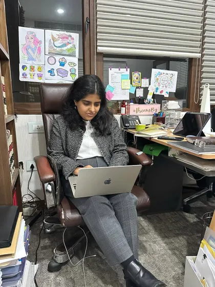 Focused at my desk, which is my command center. It might look messy, but it's an organized chaos of case files, research, and creative inspiration.