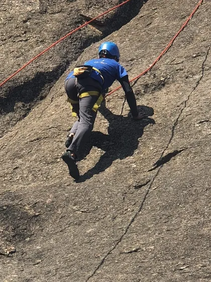 A close-up shot of a climber's technique as they move up the rock face.