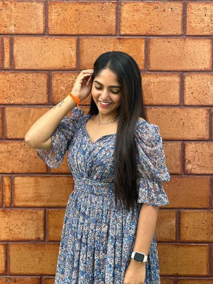 A smiling close-up of the client in her custom dress.