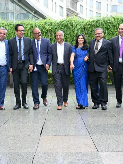 A dynamic, walking shot of a leadership team. This less formal approach to a group photo conveys forward-momentum, collaboration, and a modern corporate culture.