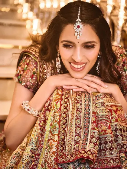 Another joyful portrait from the Garba night. The intricate details of the Tarun Tahiliani lehenga and the beautiful maang tikka are highlighted here.