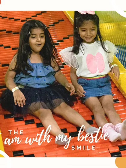 The "I'm with my bestie" smile. Playing with friends makes everything twice as fun, especially going down the slide together.