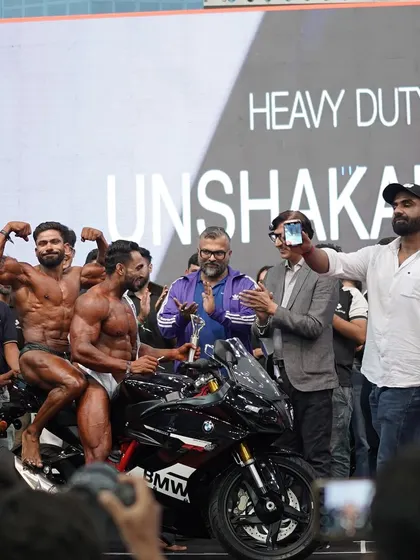 Sharing the victory with my fellow competitors. Bodybuilding is about respect and brotherhood, even when you are competing for the top spot.